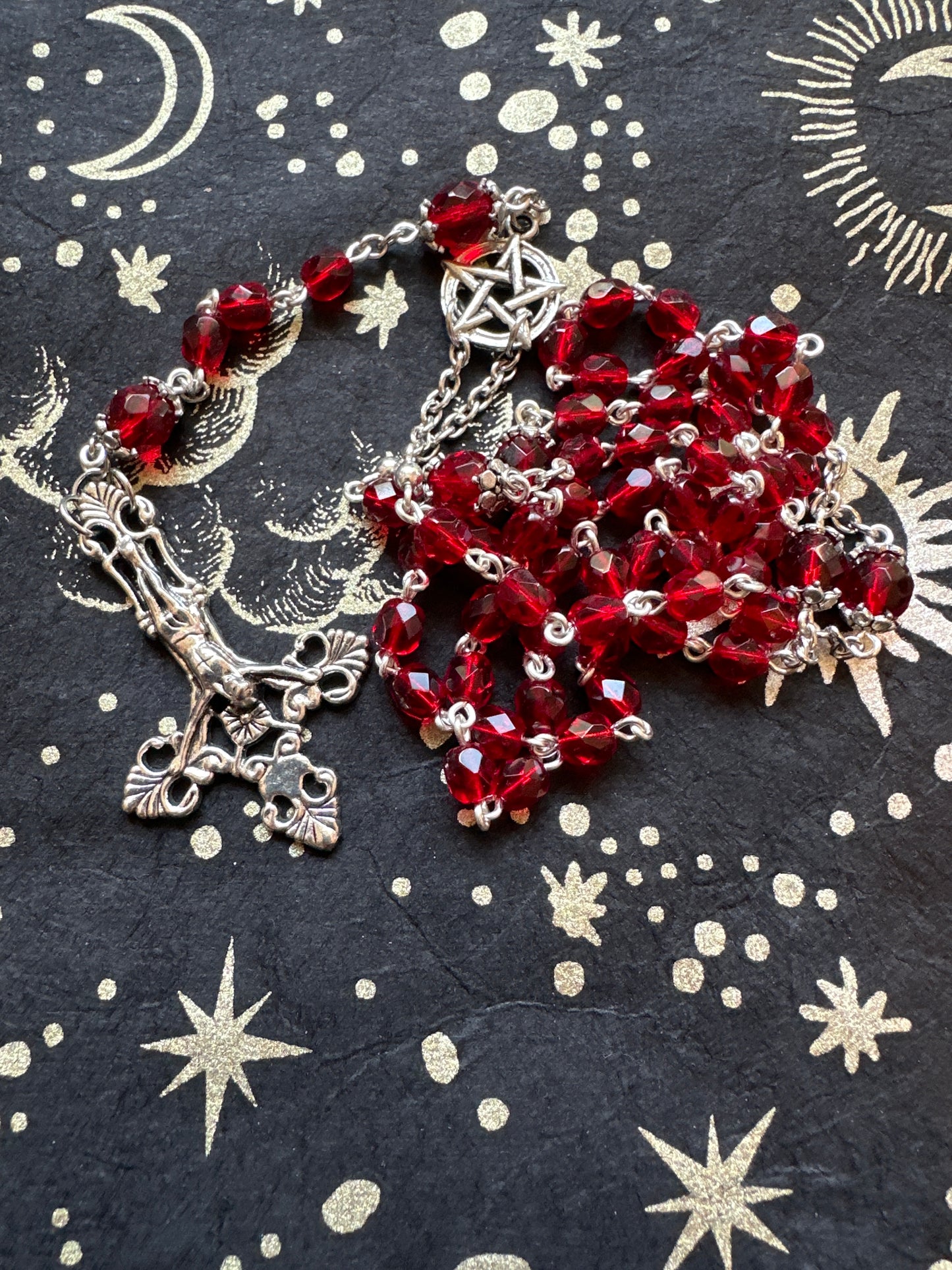 Red faceted glass rosary with inverted cross