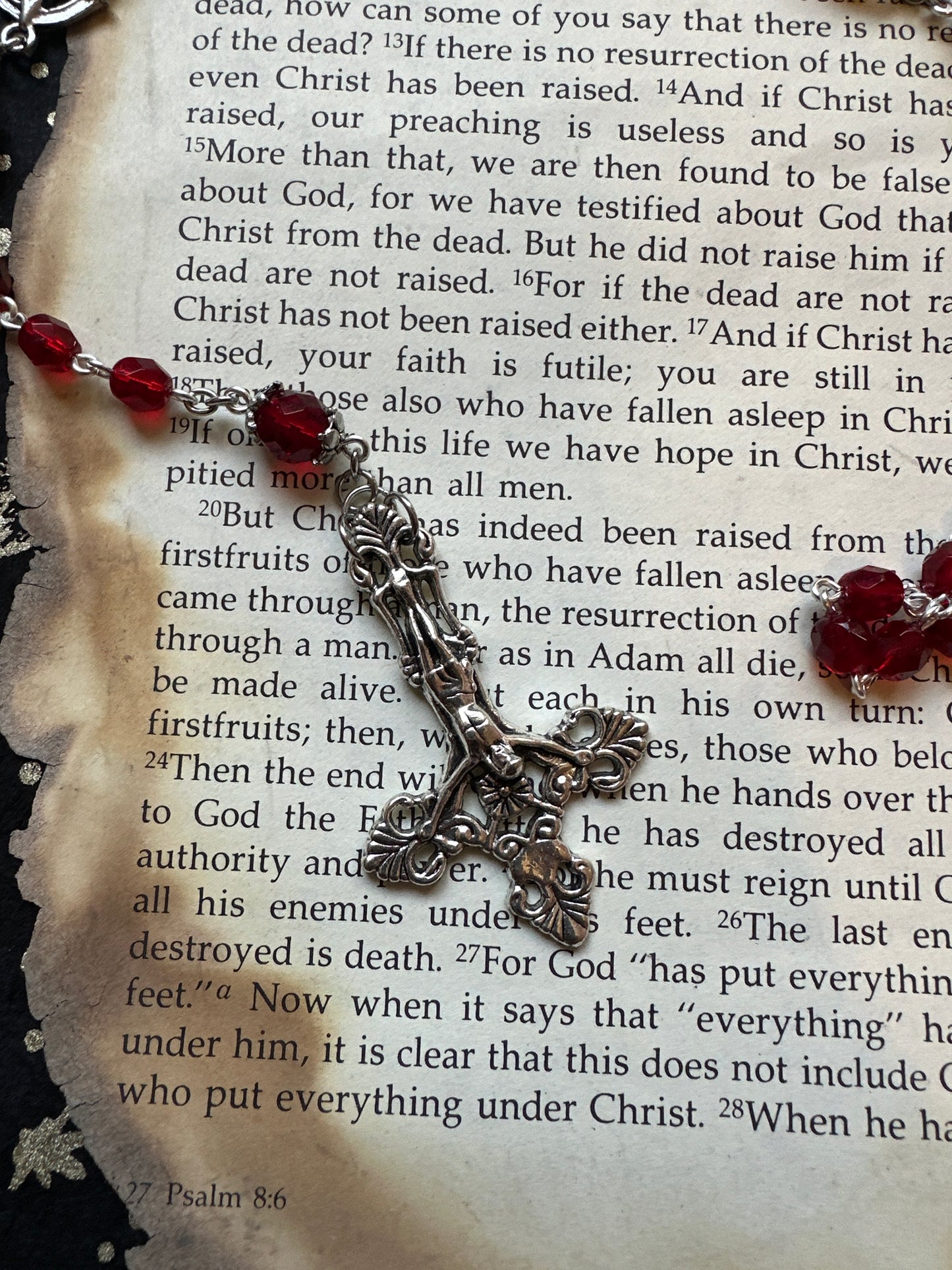 Red faceted glass rosary with inverted cross