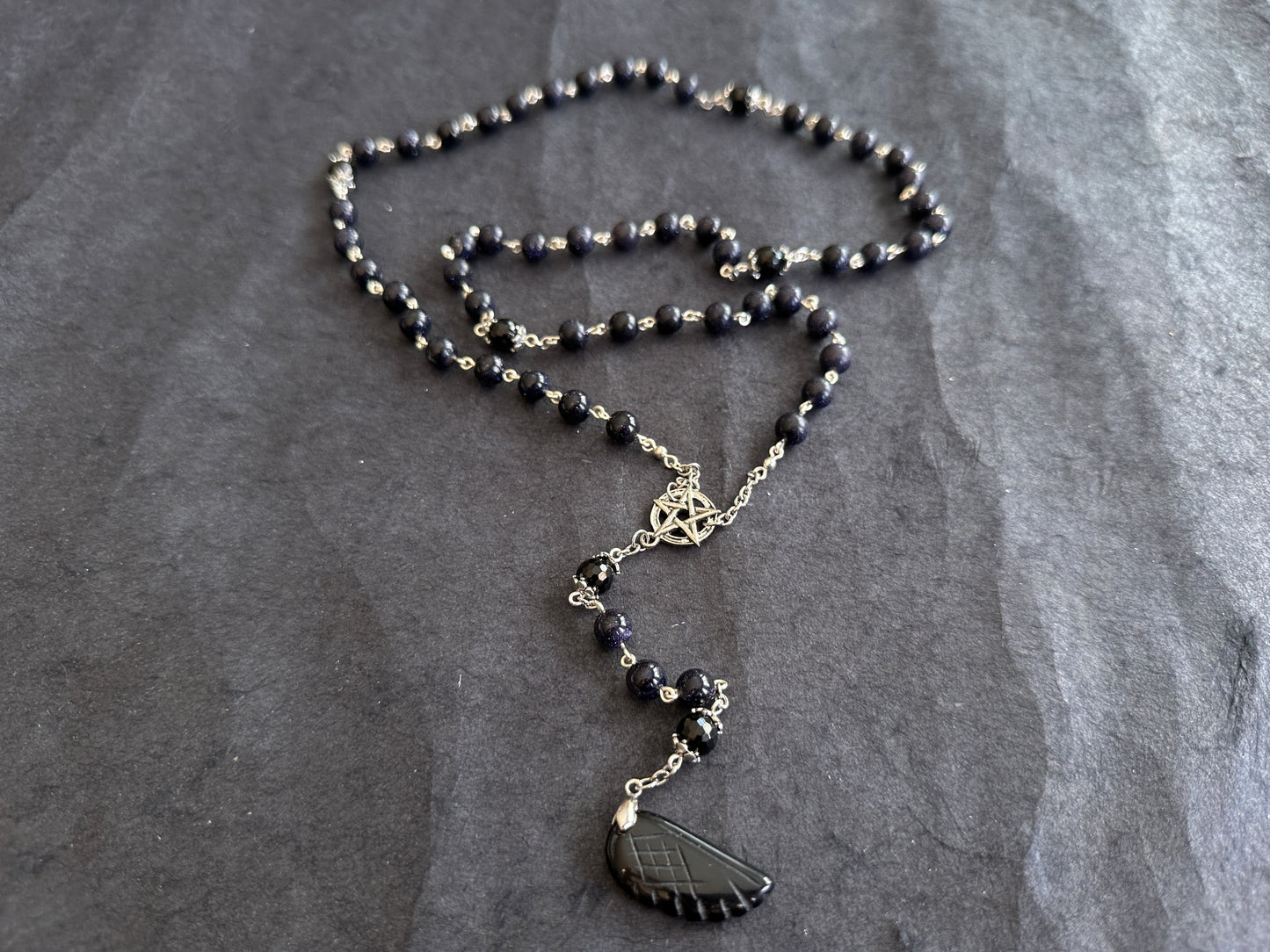 Blue goldstone rosary with black onyx pendant
