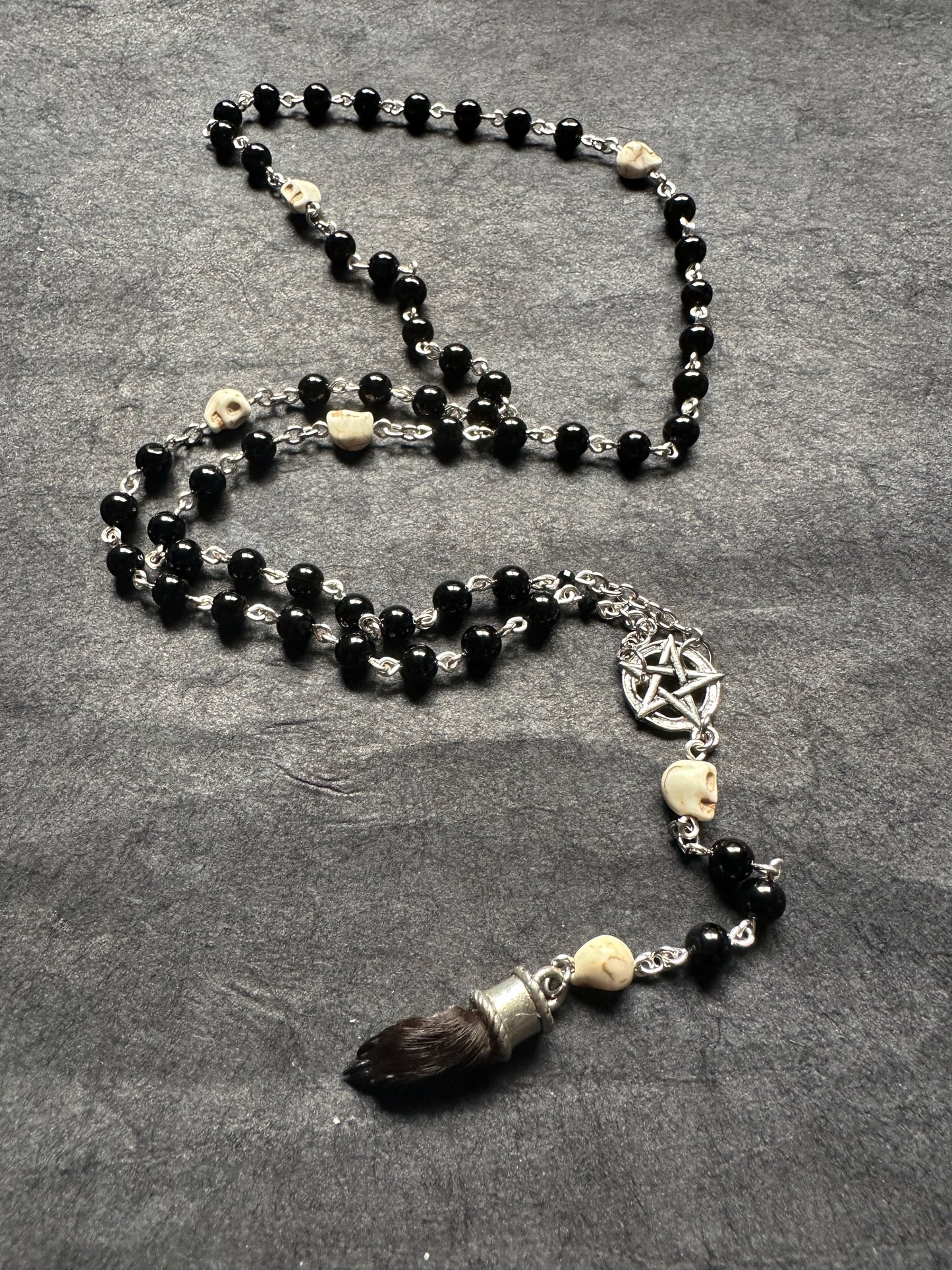 Black onyx rosary with Guinea pig paw and skull beads