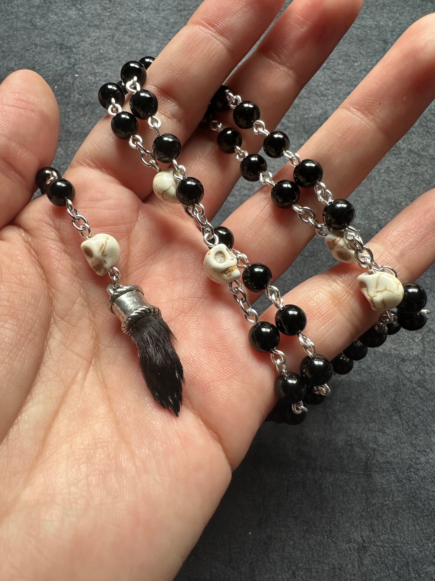Black onyx rosary with Guinea pig paw and skull beads