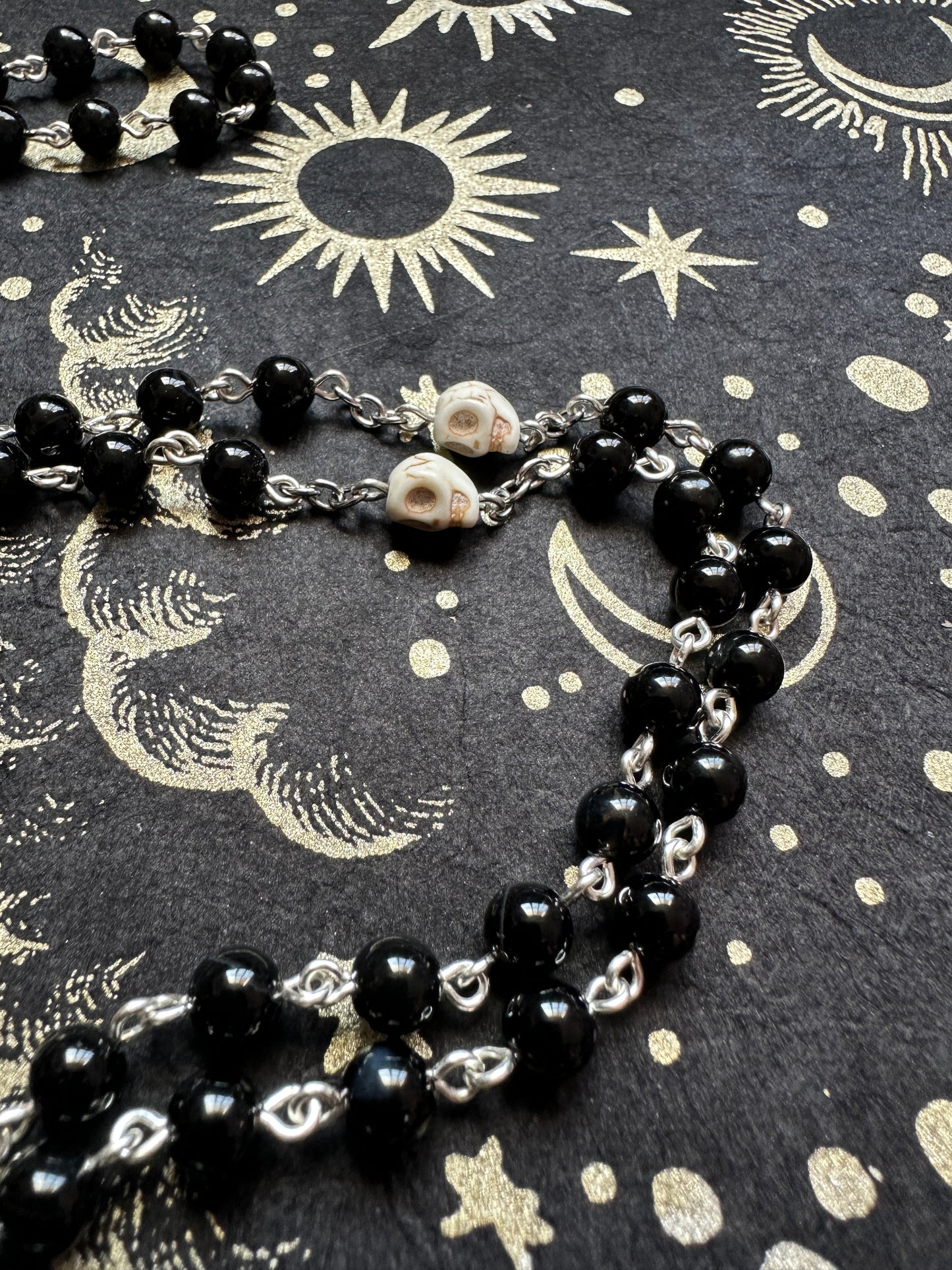 Black rosary with skull beads