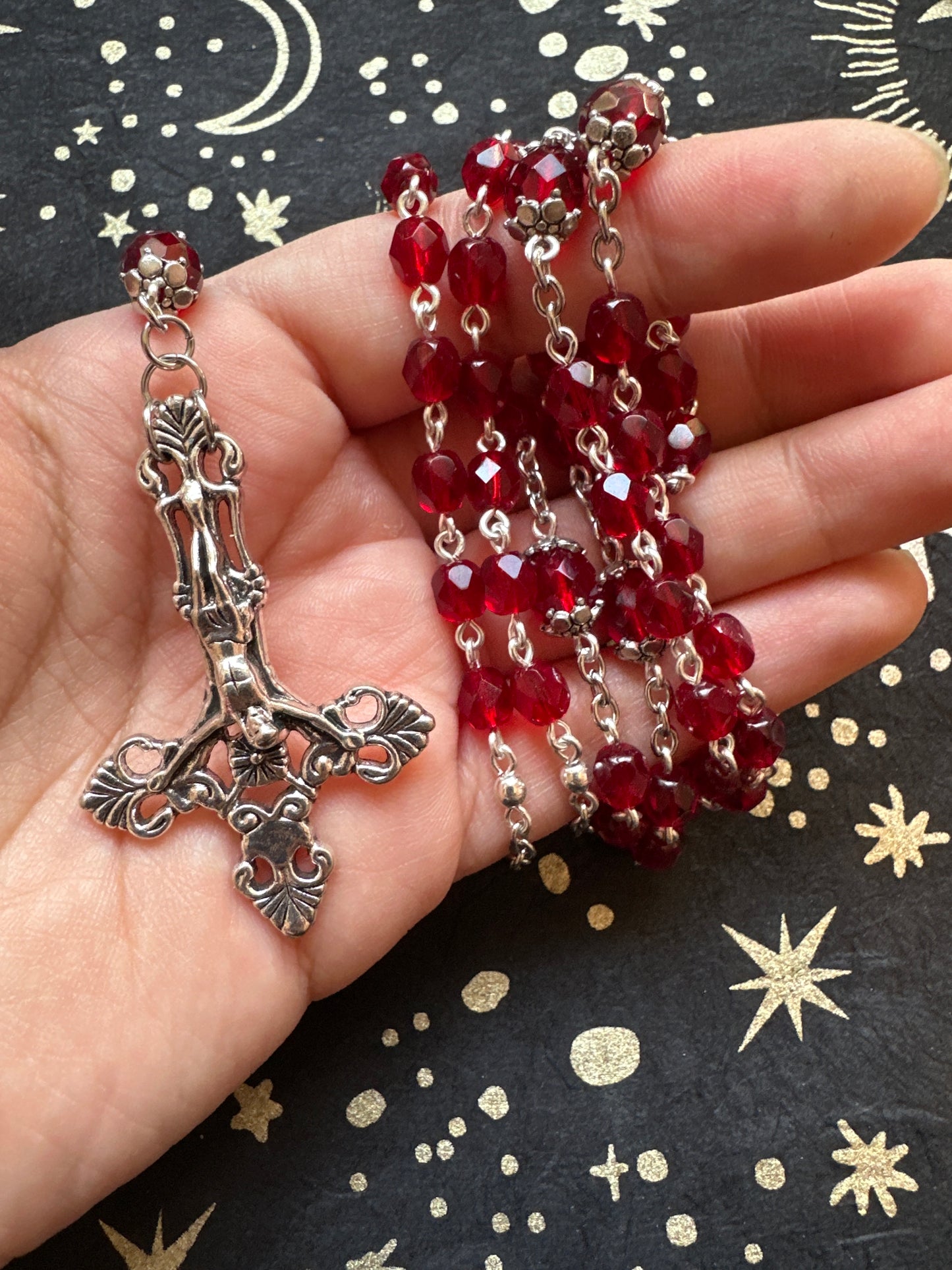 Red faceted glass rosary with inverted cross