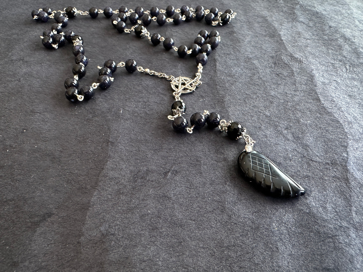Blue goldstone rosary with black onyx pendant