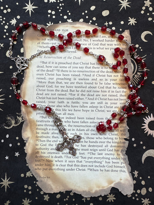 Red faceted glass rosary with inverted cross