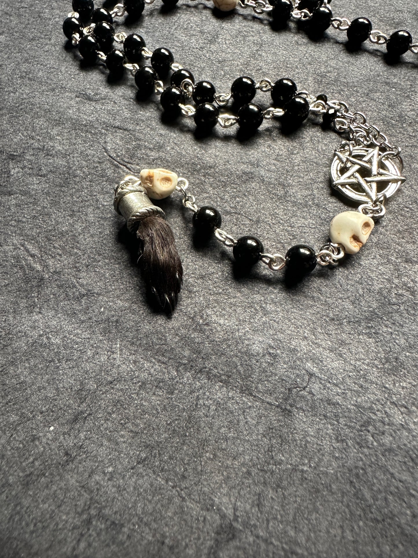 Black onyx rosary with Guinea pig paw and skull beads